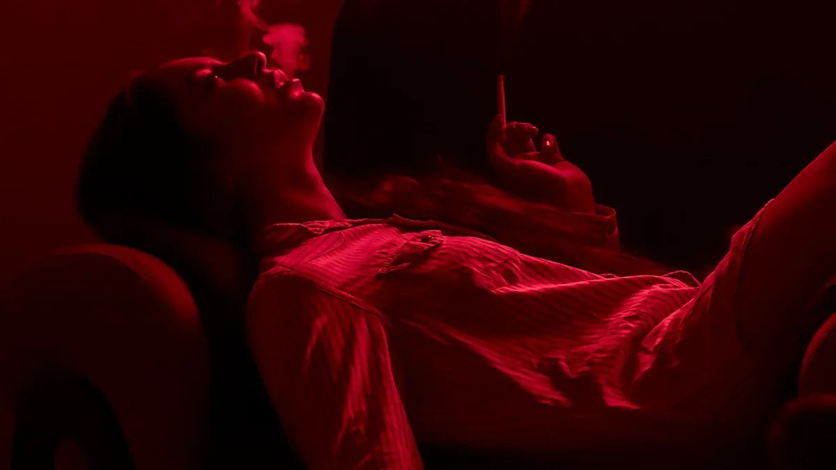 Woman relaxing under red LED light therapy for skin rejuvenation and acne treatment at home